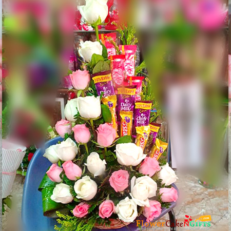 send pink white roses and assorted chocolates basket arrangement delivery